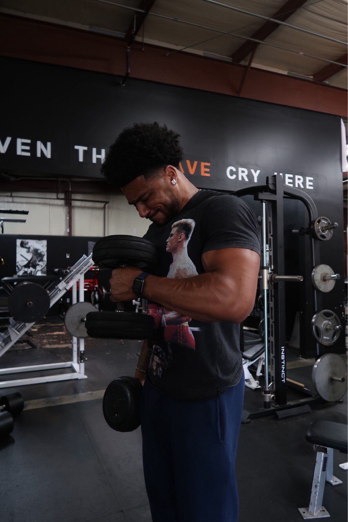 Coach Brendan performing a heavy dumbbell curl